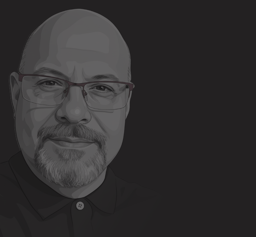 Enrique Bruzual working in a minimal office environment, reflecting 30 years of hands-on experience in digital architecture and AI systems